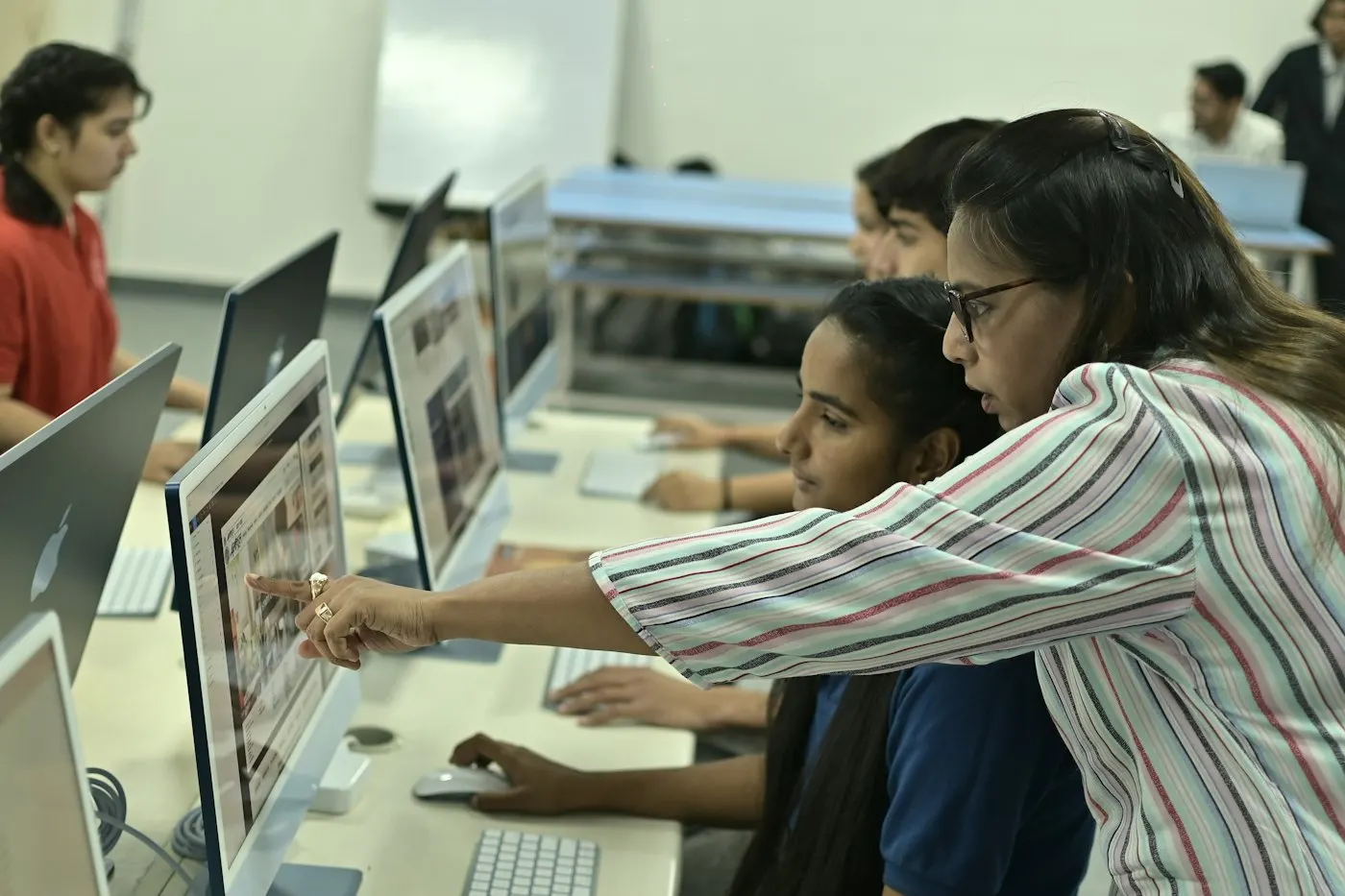 Instructor guiding students in the lab